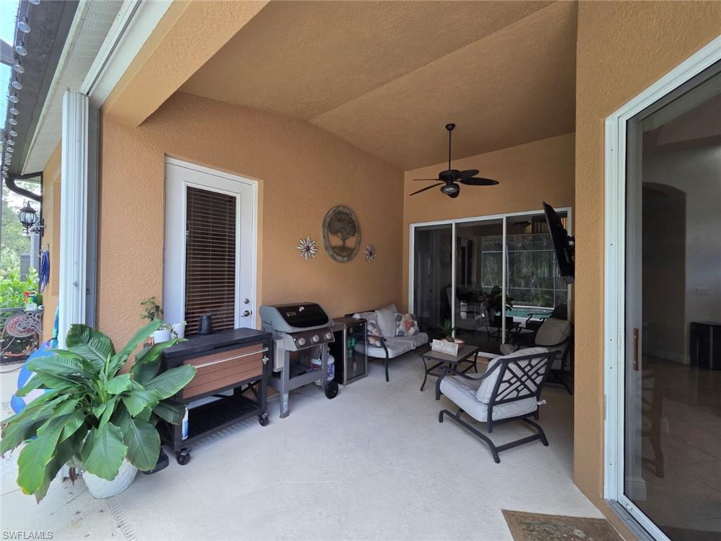 15437 Cortona Way Naples, FL 34120 - Photo 9 of 29 a outdoor space with patio couch and a potted plant