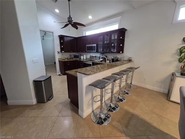 a kitchen with stainless steel appliances a sink a stove a refrigerator and cabinets