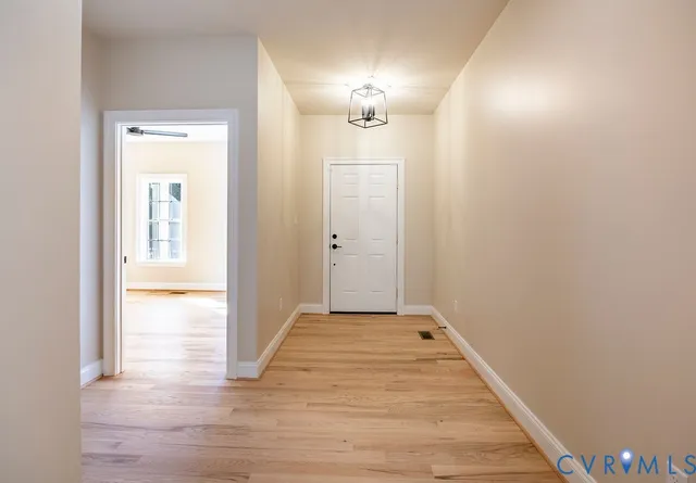 a view of a hallway with wooden floor