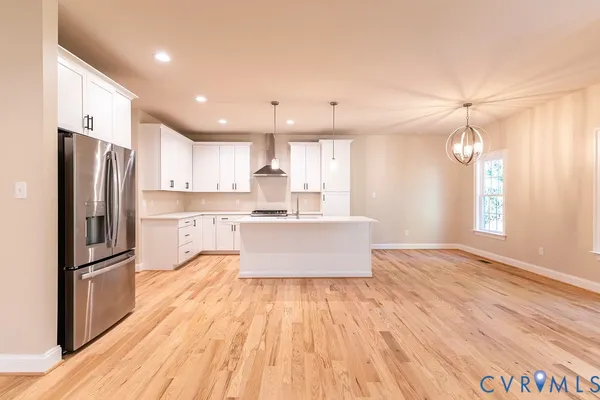 a large kitchen with kitchen island a large counter space and stainless steel appliances