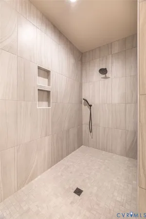 a bedroom with a bed and a shower