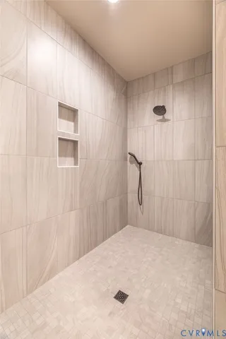 a bedroom with a bed and a shower