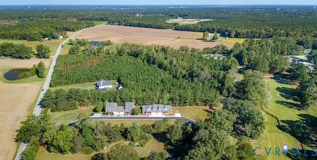 an aerial view of a house with yard and outdoor seating