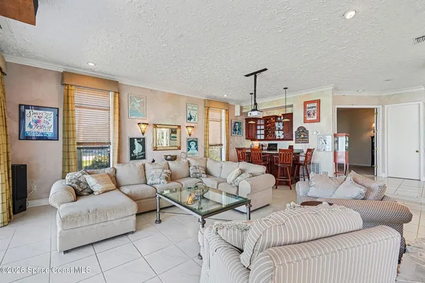 a kitchen with stainless steel appliances kitchen island granite countertop a refrigerator and a dining table