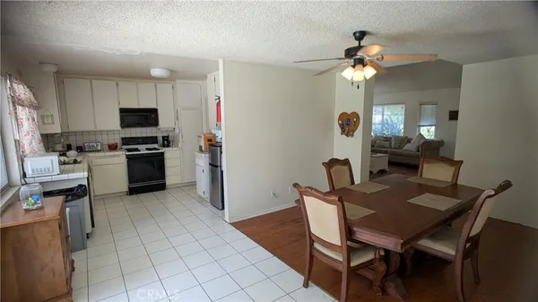 a kitchen with kitchen island a dining table and chairs