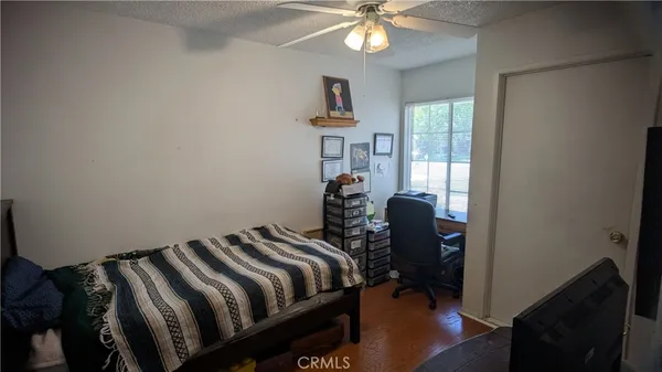 a bed room with a bed and a chair