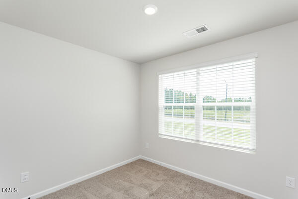64 Rider Street Broadway, NC 27505 - Photo 7 of 11 an empty room with a window