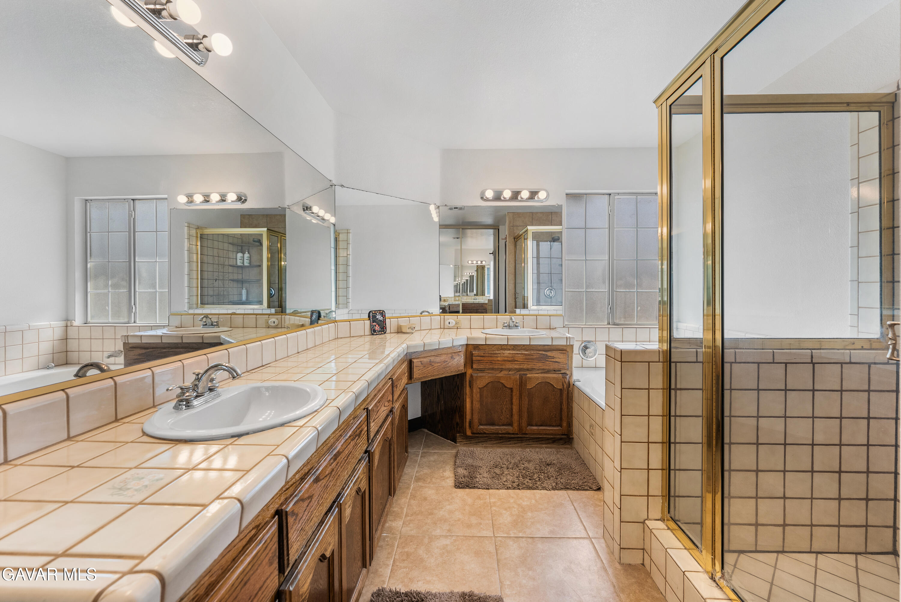 40508 154th Street East Lancaster, CA 93535 - Photo 16 of 20 a spacious bathroom with a granite countertop sink mirror and bathtub