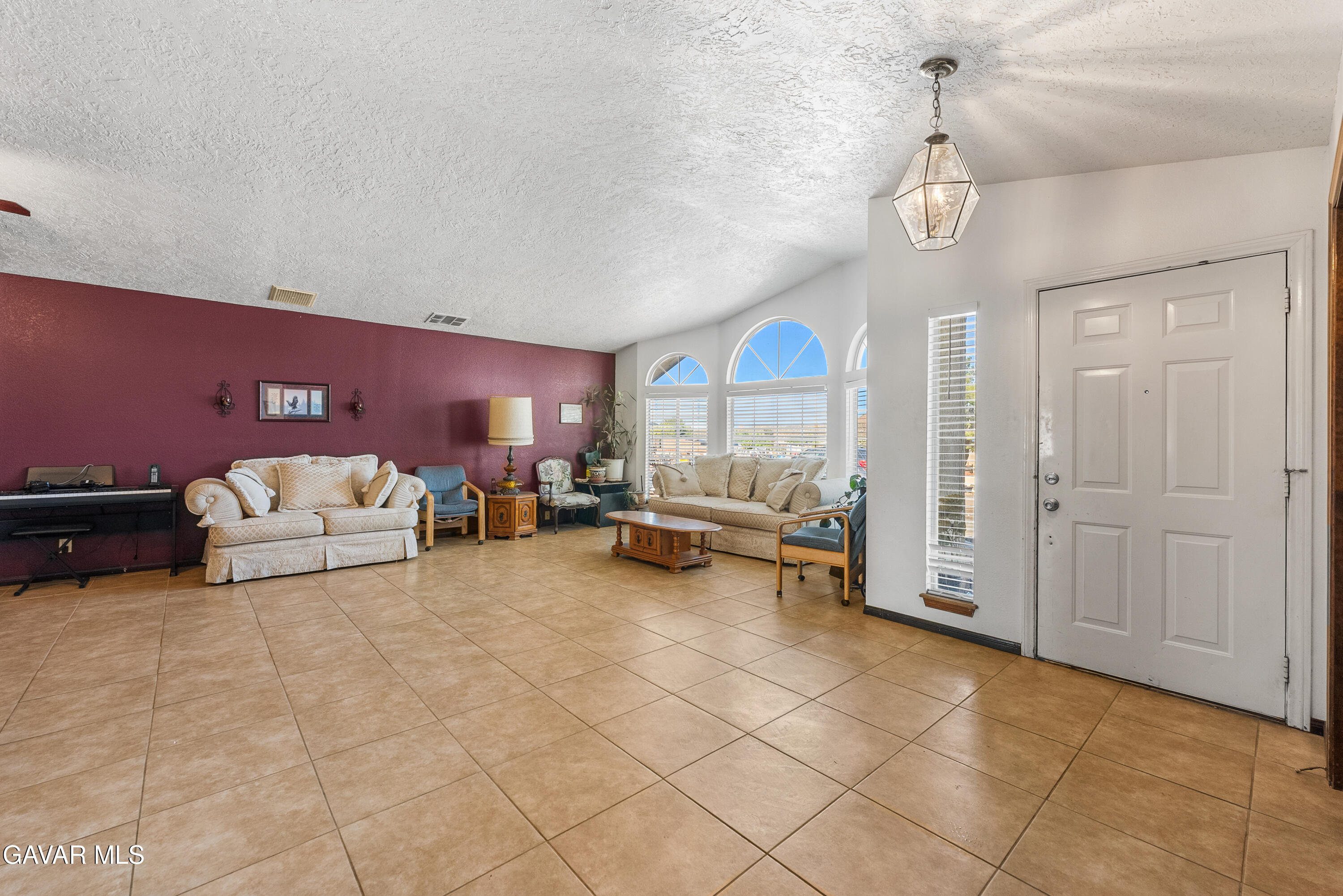 40508 154th Street East Lancaster, CA 93535 - Photo 5 of 20 a living room with furniture and a dining table with wooden floor