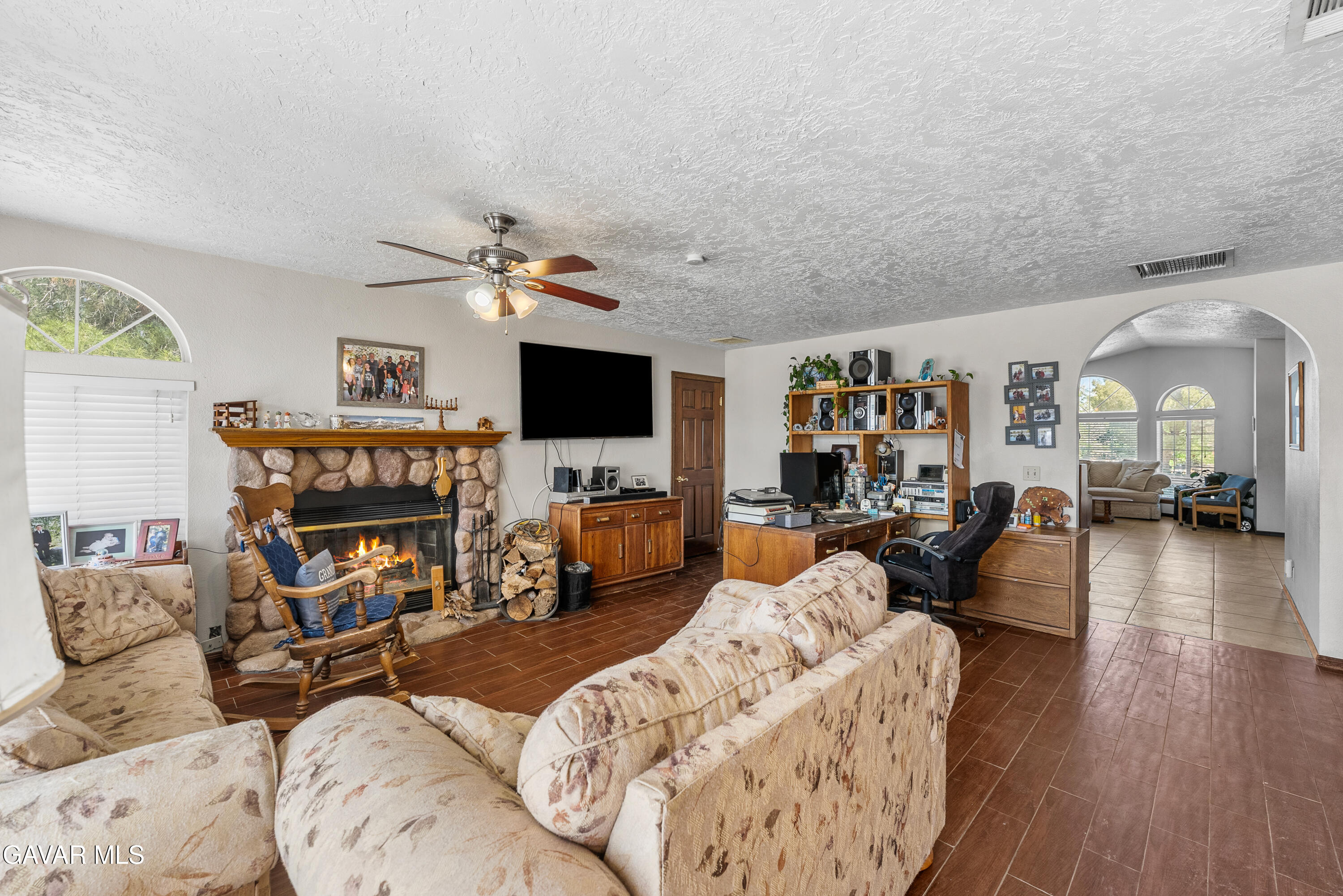 40508 154th Street East Lancaster, CA 93535 - Photo 8 of 20 a living room with furniture a fireplace and a flat screen tv
