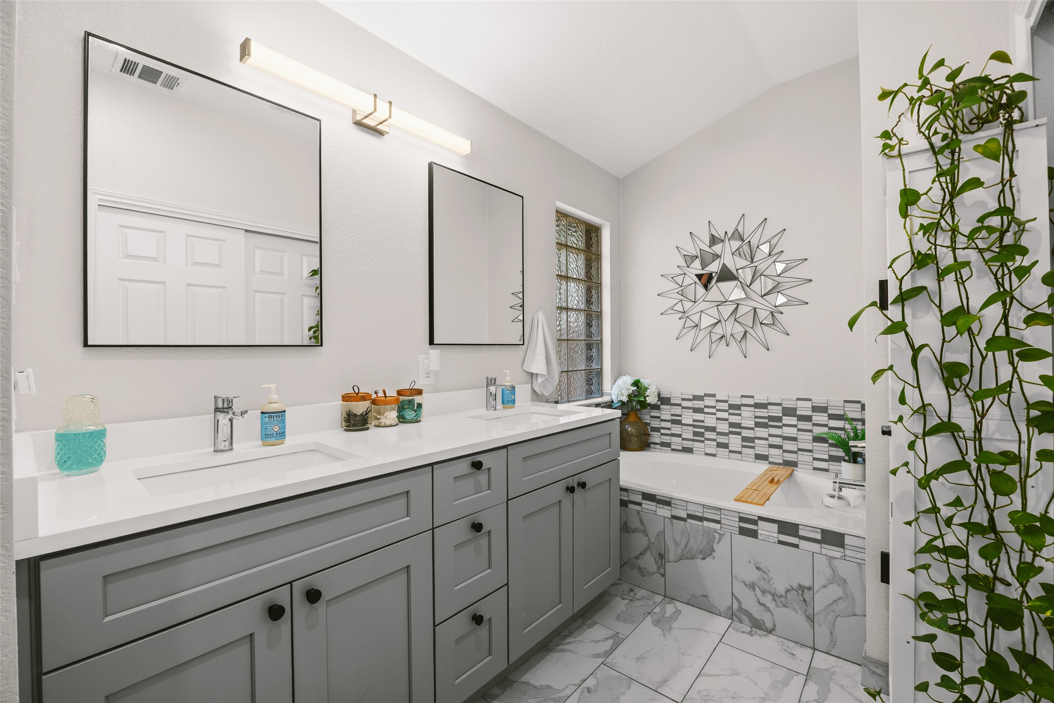 2202 Old Mill Road Cedar Park, TX 78613 - Photo 17 of 23 A well-appointed primary bathroom showcases a dual vanity with ample storage and a built-in tub.