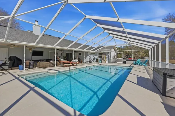 a view of a swimming pool with sitting area