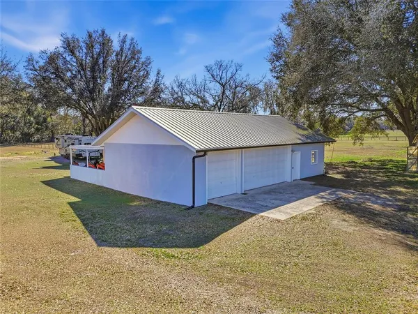 a view of a house with a backyard porch and sitting area