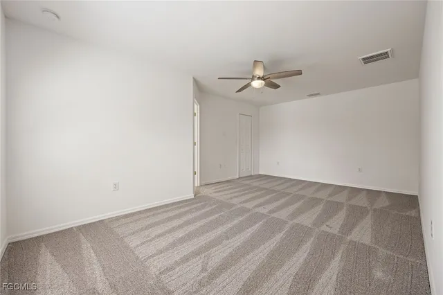 a view of a big room with a ceiling fan and a chandelier fan
