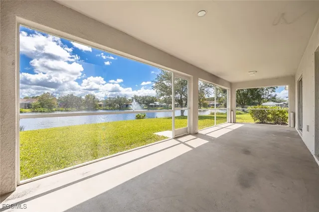 a view of a lake and a yard from a balcony