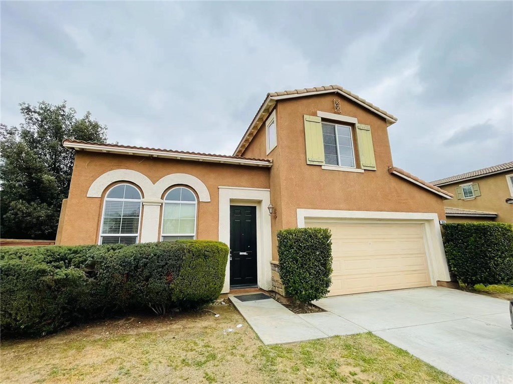 3865 Bella Torre Road Perris, CA 92571 - Photo 1 of 1 a front view of a house with a yard and garage