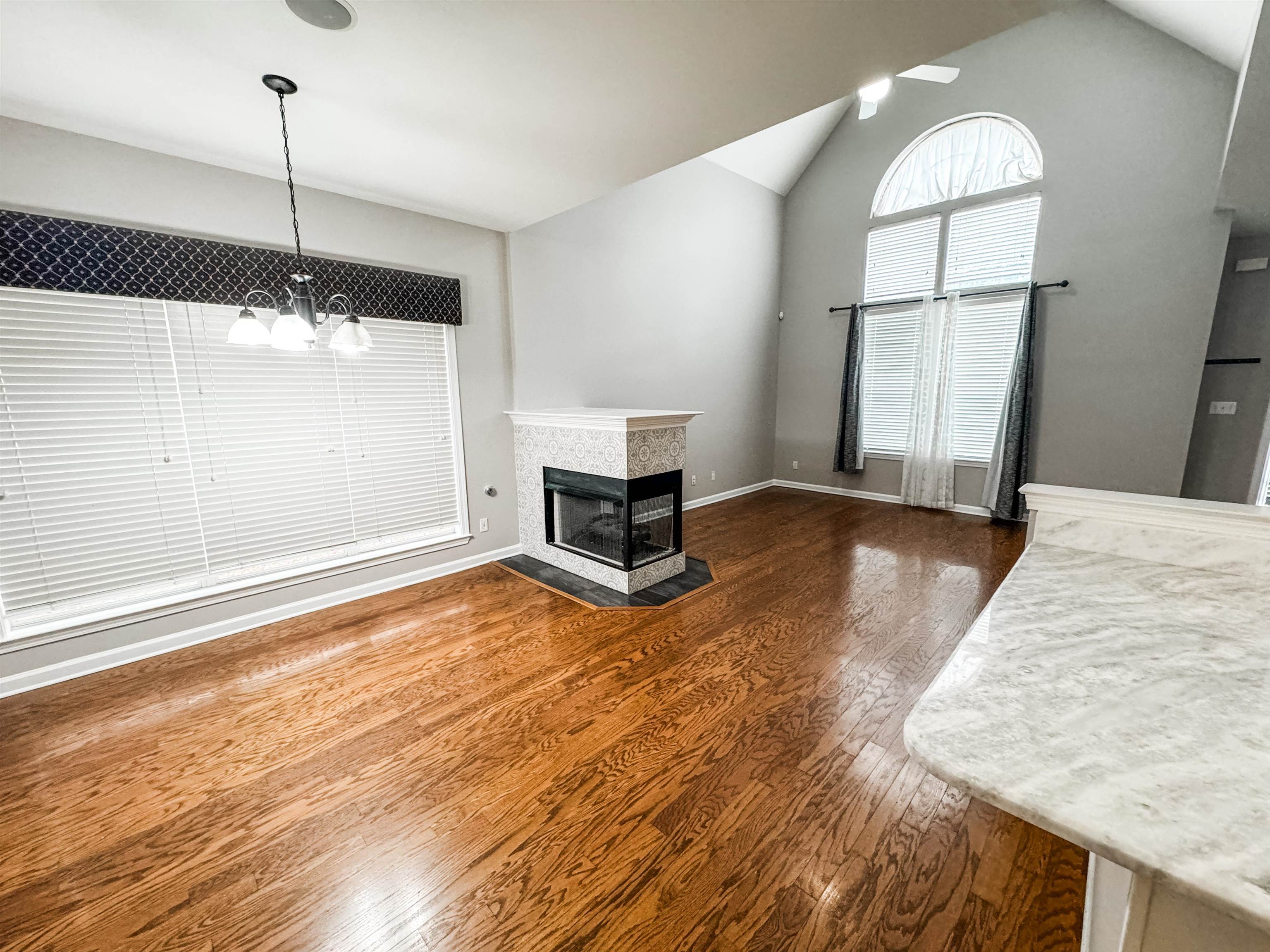 4564 Park Ridge Parkway Collierville, TN 38017 - Photo 4 of 12 a view of a room with wooden floor a ceiling fan and window