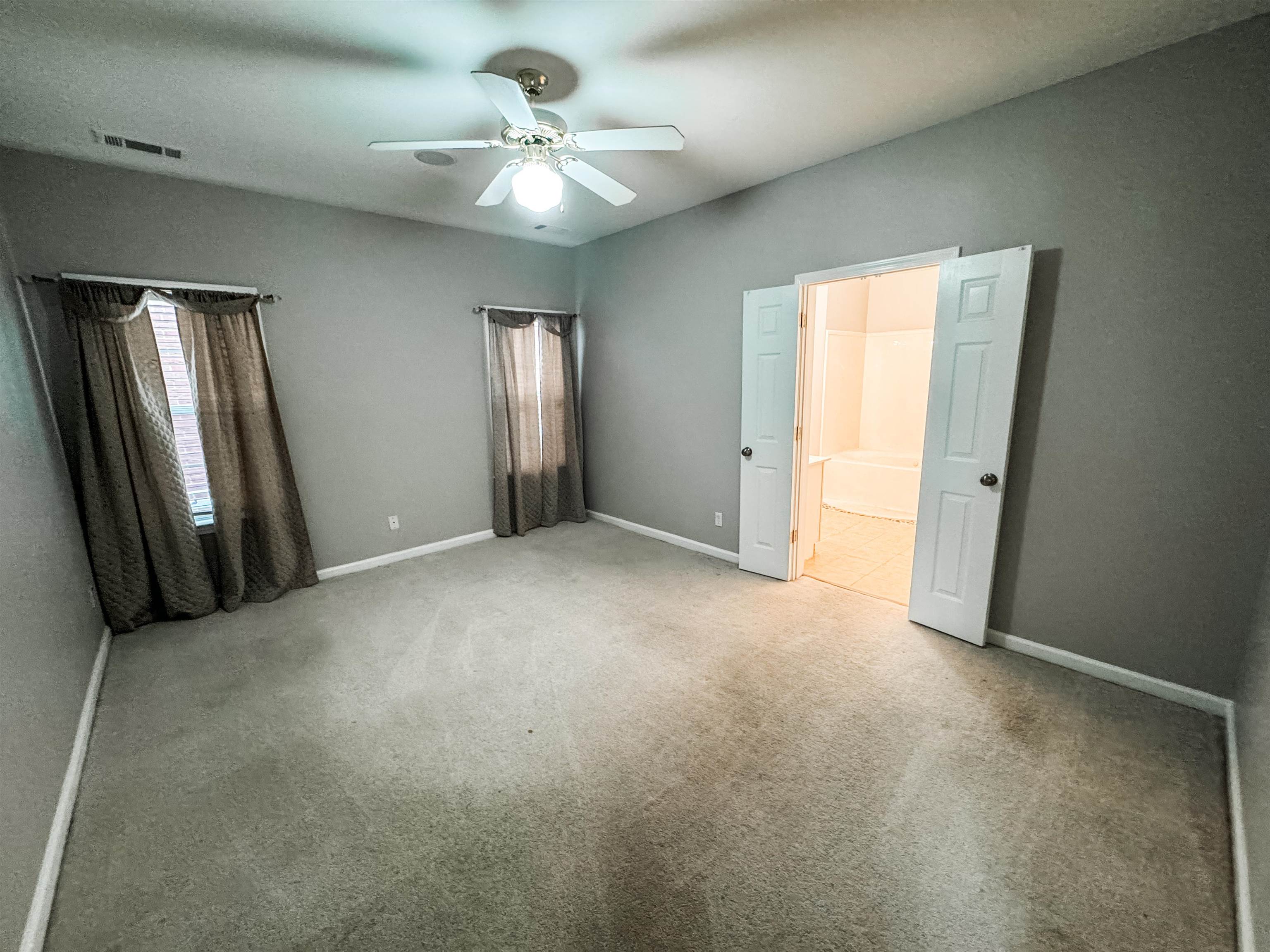 4564 Park Ridge Parkway Collierville, TN 38017 - Photo 5 of 12 an empty room with windows and fan