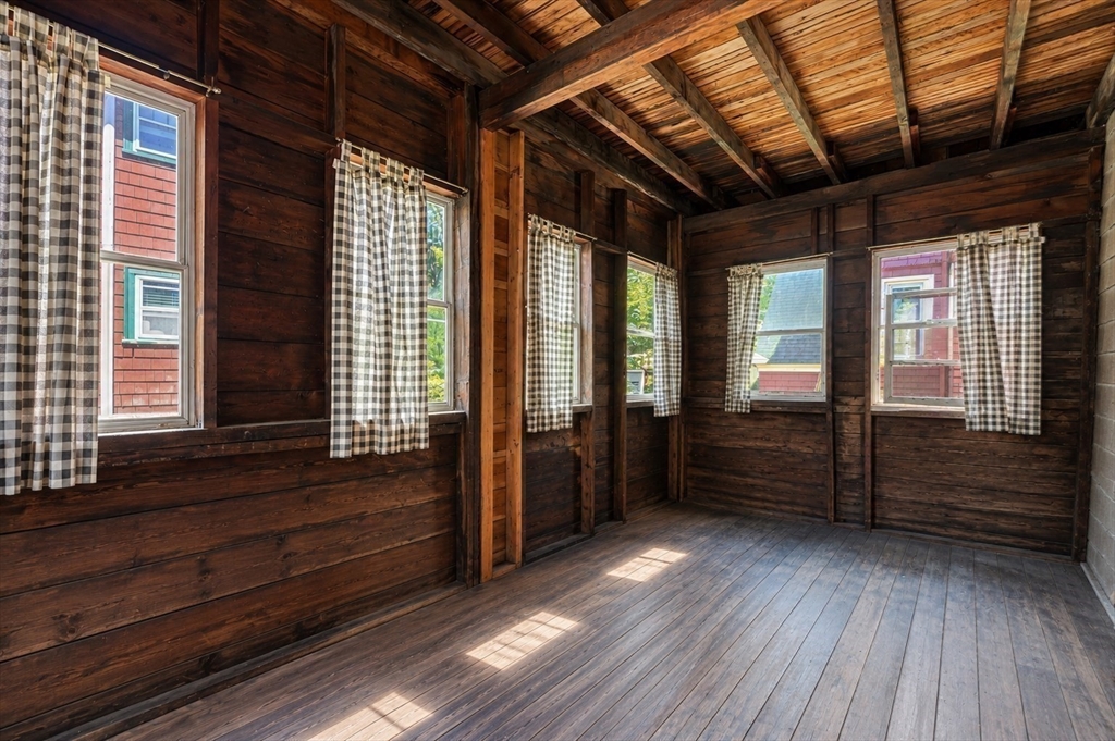 157 Elm Street Somerville, MA 02144 - Photo 17 of 19 a room with wooden floors and furniture