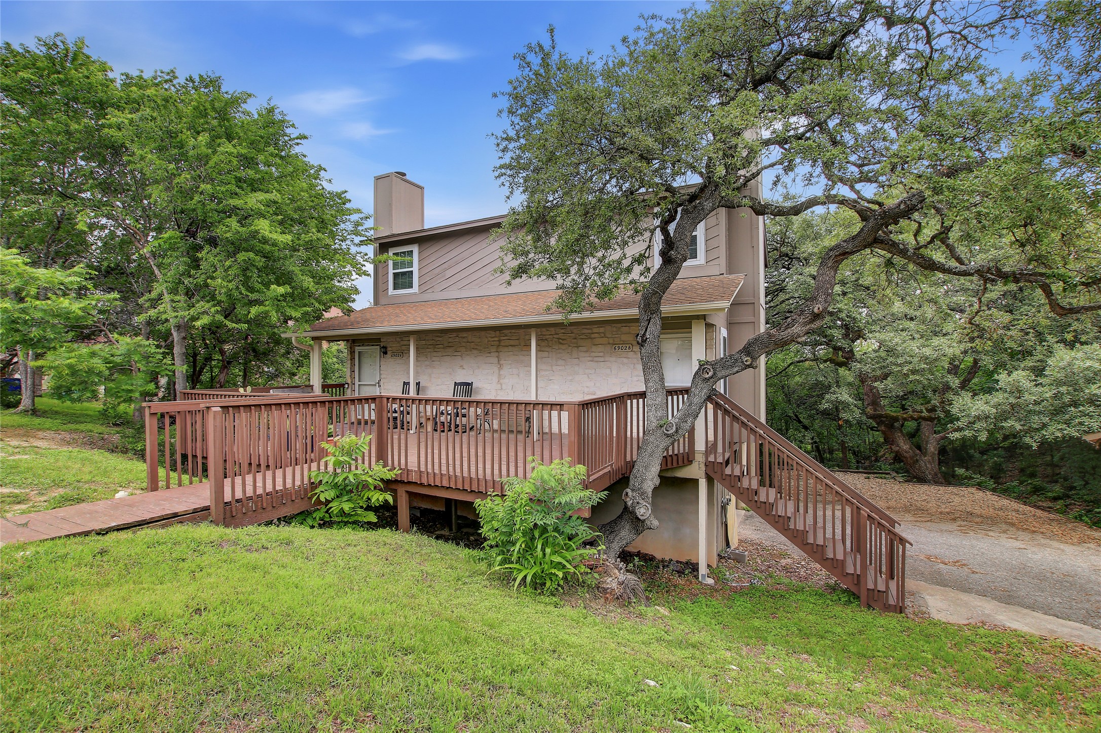 6902 Rifle Bend, Unit B Austin, TX 78736 - Photo 20 of 34 a view of a house with a yard plants and large tree