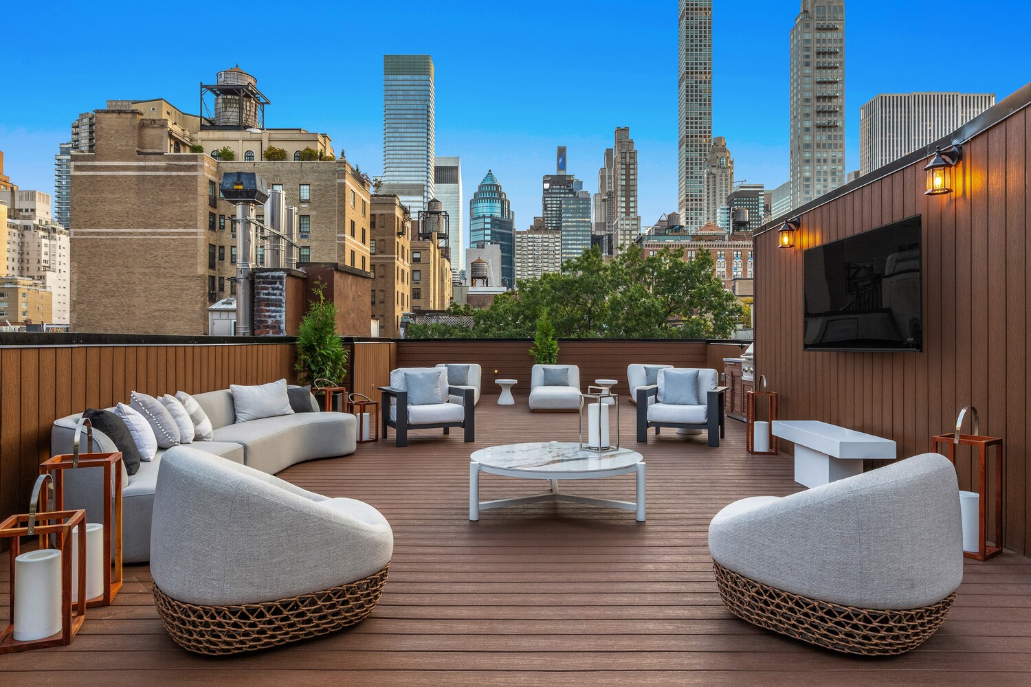 125 East 65th Street Manhattan, NY 10065 - Photo 1 of 26 a living room with furniture and a flat screen tv