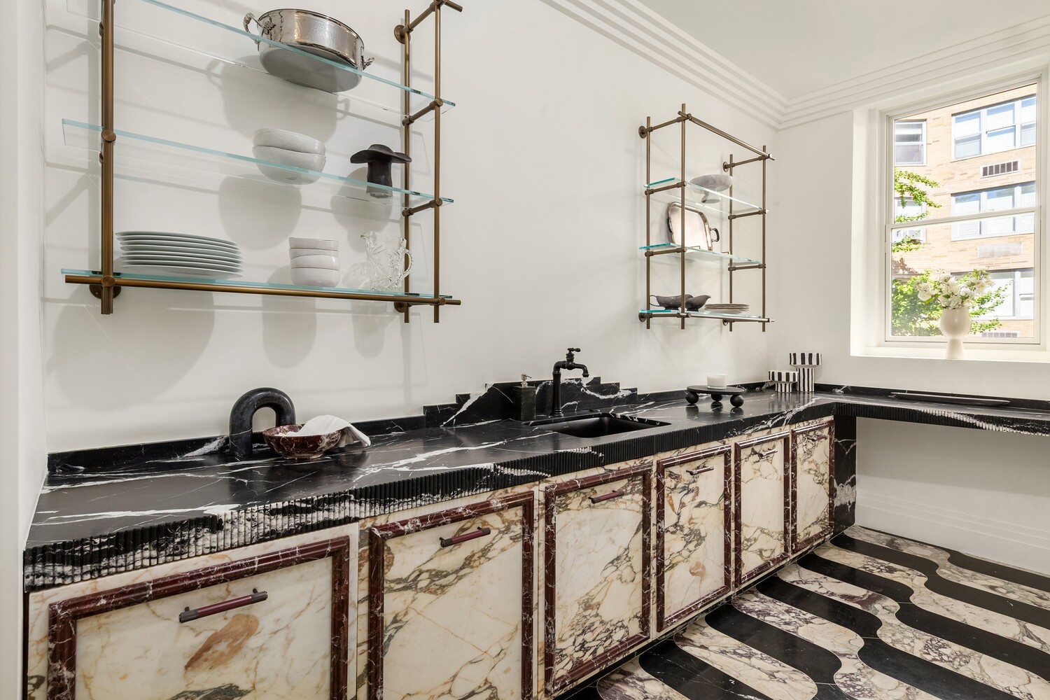 125 East 65th Street Manhattan, NY 10065 - Photo 7 of 26 a kitchen with a sink stove top oven and cabinets
