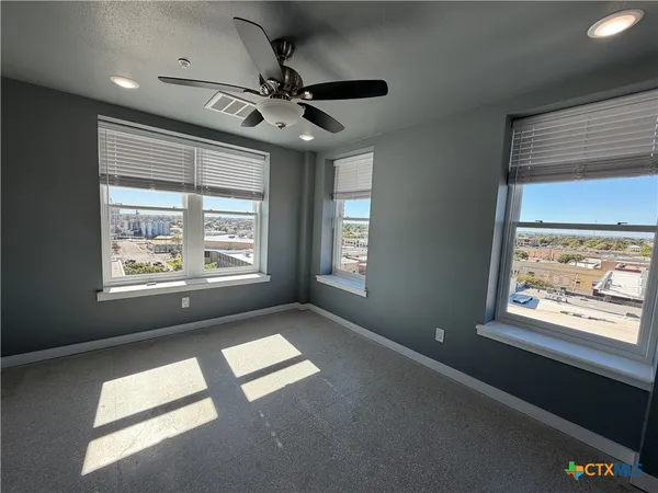 a view of room with a ceiling fan and window