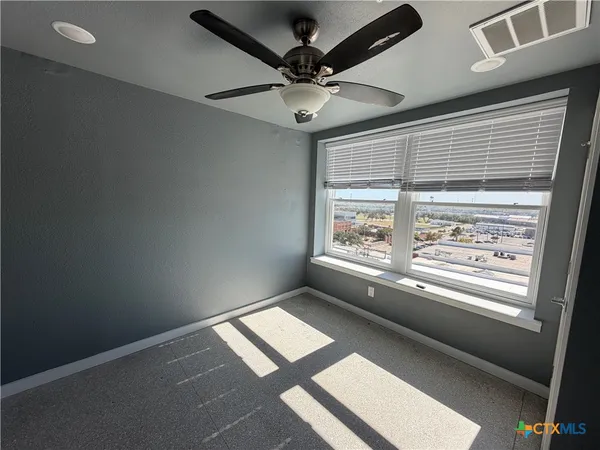 a view of an empty room with a window