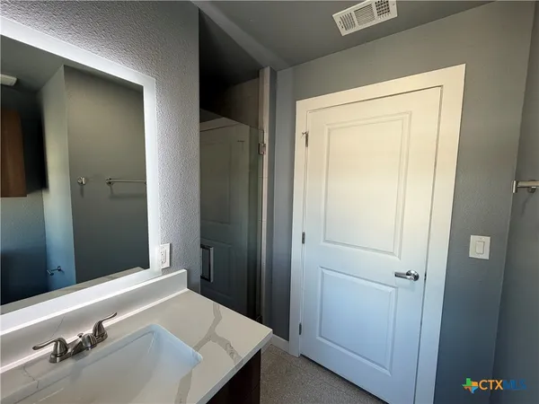a bathroom with a sink and a mirror