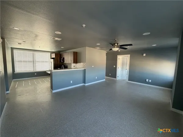 a view of a kitchen with a sink and a window