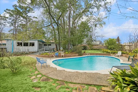 a view of a swimming pool with a patio
