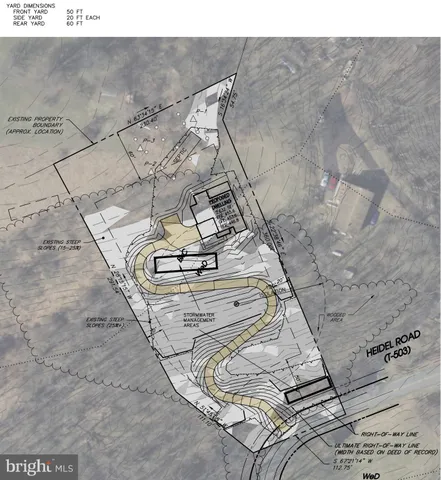 a view of a yard with wooden fence