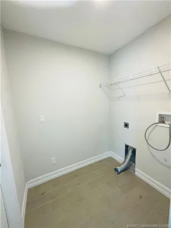 a view of a room with wooden floor and cabinets