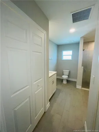 a spacious bathroom with a toilet and a shower
