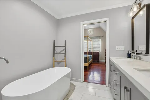 a bathroom with a double vanity sink toilet mirror and shower