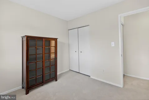 an empty room with closet area