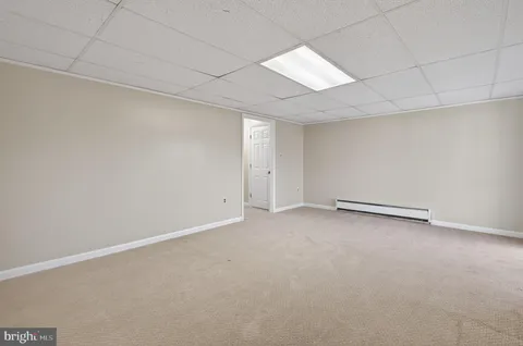 an empty room with a empty space and windows