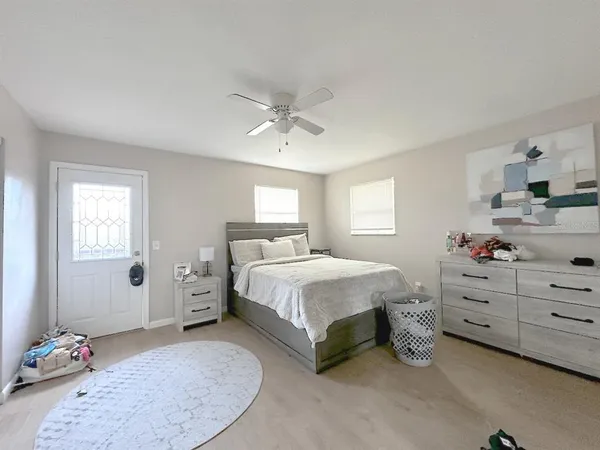 a spacious bedroom with a bed and window