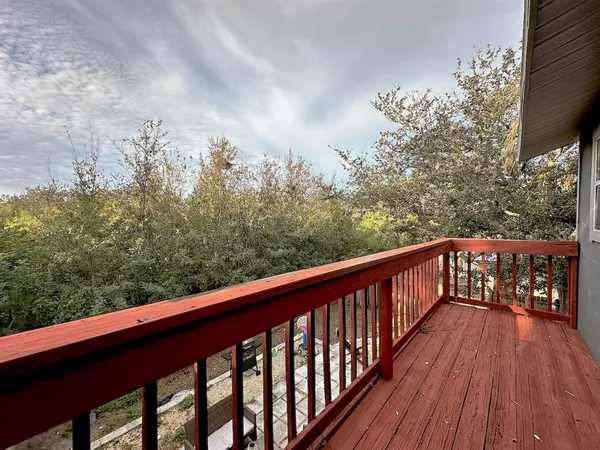 a balcony with wooden floor and fence