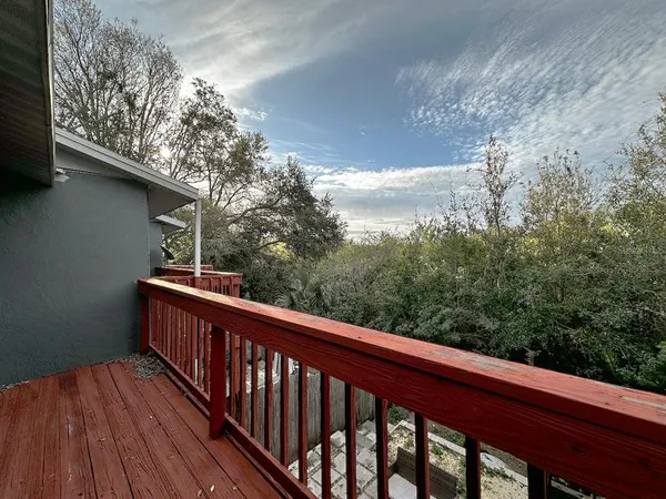 a view of balcony with wooden floor