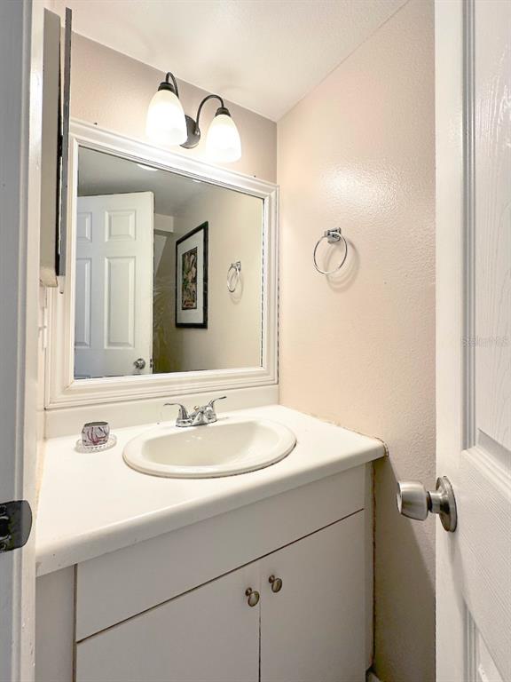 1713 Azalea Court, Unit A Oldsmar, FL 34677 - Photo 14 of 38 a bathroom with a sink and a mirror