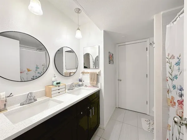 a bathroom with a sink double vanity and a mirror