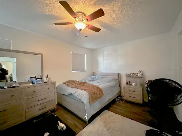 a bedroom with a bed and a chandelier