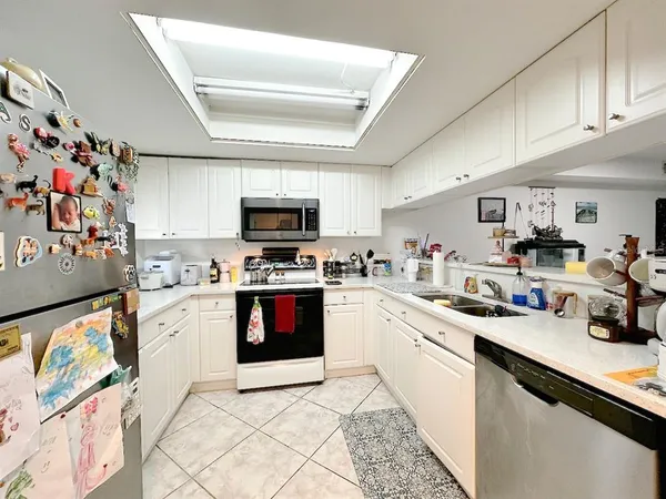 a kitchen with granite countertop stainless steel appliances and sink