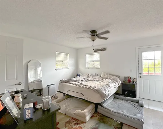 a bedroom that has a bed and a chandelier