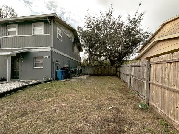a front view of a house with wooden fence
