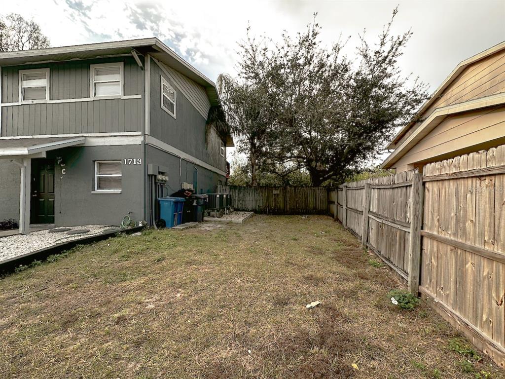 1713 Azalea Court, Unit A Oldsmar, FL 34677 - Photo 33 of 38 a front view of a house with wooden fence