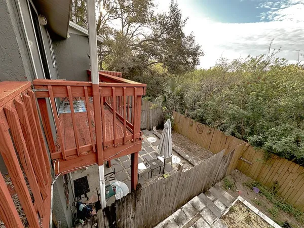 a view of balcony with wooden floor and fence