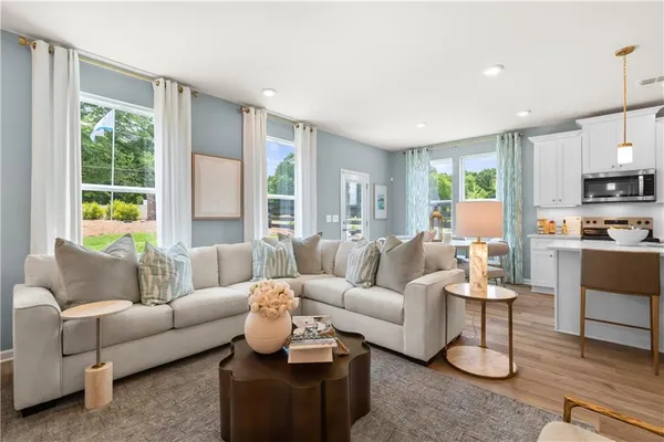 a living room with furniture and a large window