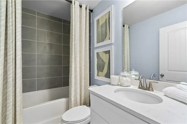 a bedroom with a bed dresser and a window